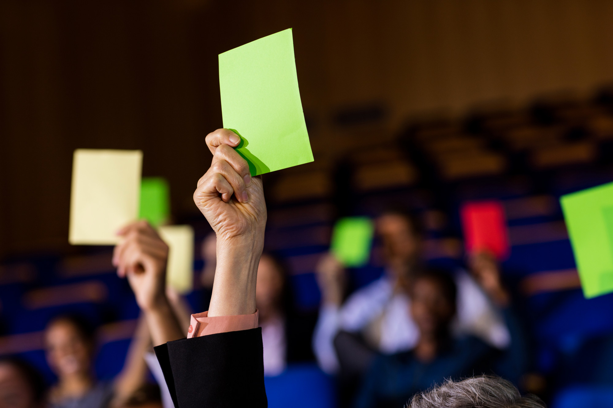 business-executives-show-their-approval-by-raising-hands